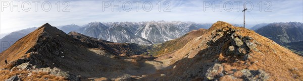 Panorama, summit cross on the ridge of the Venet, view of mountains in the Parzinn group in the