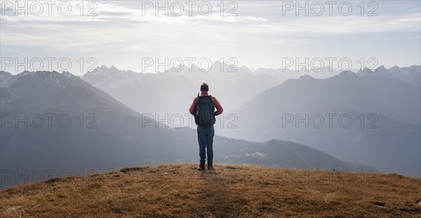 Mountaineers in front of a mountain panorama in the morning light, view from the Venet in autumn,