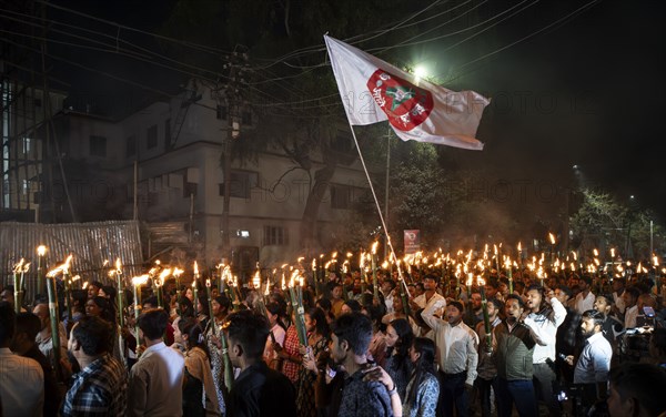 Members of the All Assam Students' Union (AASU) take part in a flaming torch rally and shout