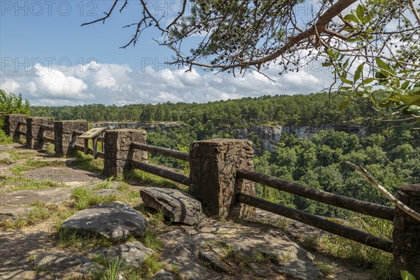 Stone and timber railing along the edge of a cliff at an overlook along the Little River Canyon Rim