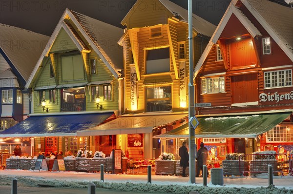 People sitting in front of a bar, winter, chrismas decoration, cold, gas powered heating stove
