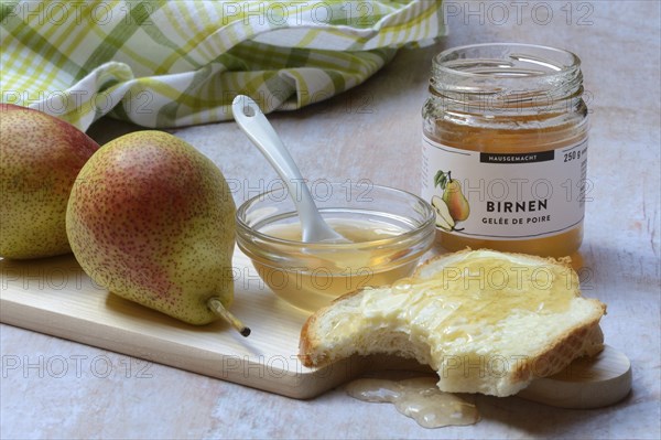 Pear jelly in a bowl and glass, pear jelly on a slice of bread