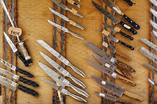Traditional Portuguese knives in front of a souvenir shop, different shapes and materials, Ã“bidos,