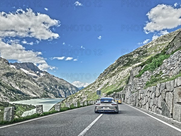 Photo with reduced saturation Porsche 911 GT3 on pass road of Grimselpass, Canton Uri, Switzerland,
