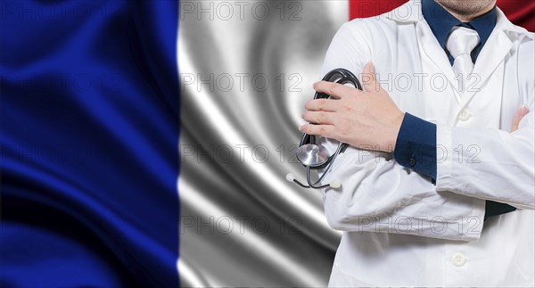 Doctor with stethoscope on French flag. Doctor with arms crossed on French flag background. Medical