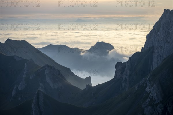 Hoher Kasten and mountains at sunrise, high fog in the valley, view from SÃ¤ntis, Appenzell