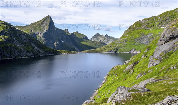 Lake Tennesvatnet and mountain landscape with rocky pointed peaks, Hermannsdalstinden mountain in