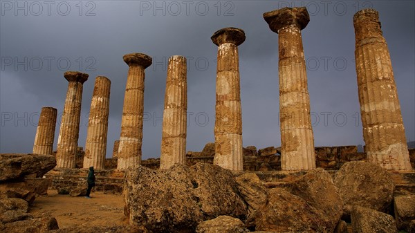 Row of columns, chapter, Heracles temple, dark clouds, sun, thunderstorm atmosphere. Valley of the