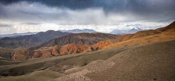 View over eroded mountainous landscape of Konorchek Canyon with red sandstone cliffs, high