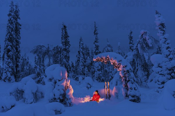 Man at the campfire, Muddus National Park, World Heritage Laponia, Norrbotten, Lapland, Sweden,