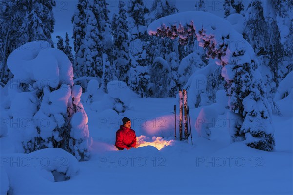 Man at the campfire, Muddus National Park, World Heritage Laponia, Norrbotten, Lapland, Sweden,