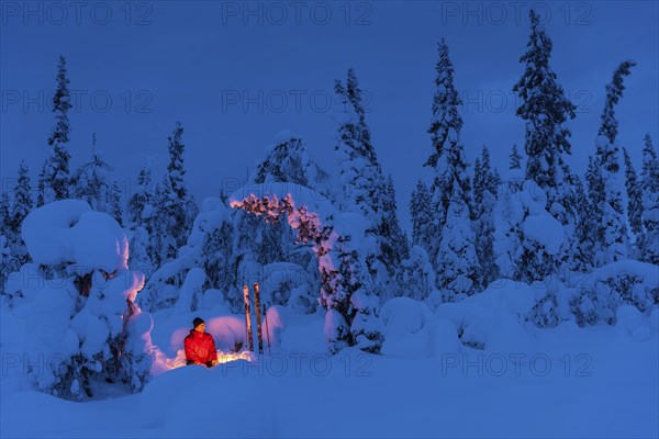 Man at the campfire, Muddus National Park, World Heritage Laponia, Norrbotten, Lapland, Sweden,