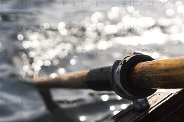Closeup photo of wooden paddle used for rowing in the water, lake Bled