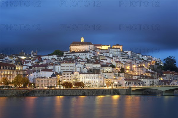 Coimbra city view at night with Mondego river and beautiful historic buildings, in Portugal