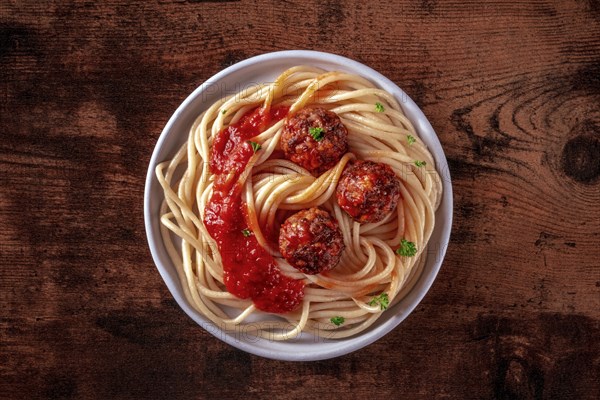 Meatballs. Beef meat balls, overhead shot with spaghetti pasta, parsley, and tomato sauce, on a