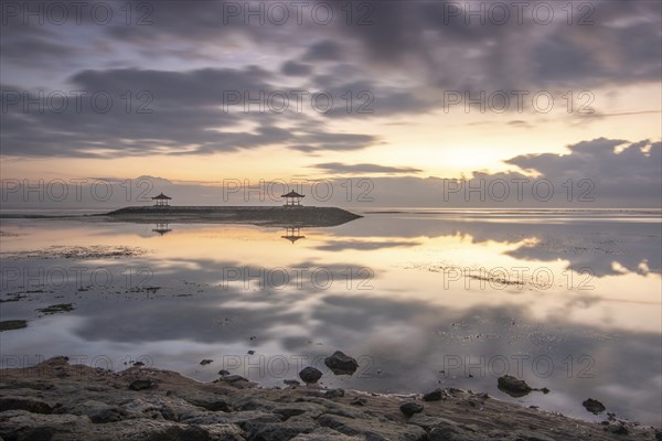 Beautiful seascape in the morning. Tropical sandy beach with breakwater and reflection of the sky