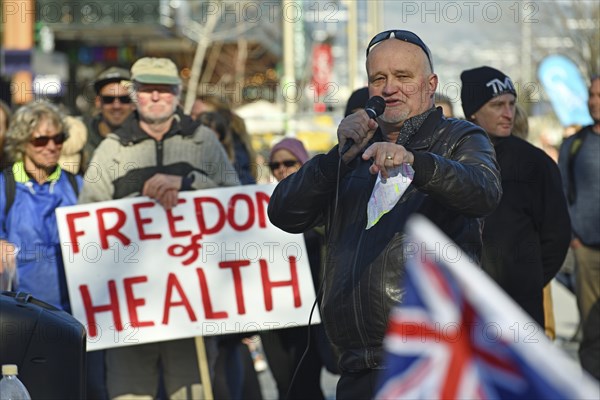 CHRISTCHURCH, NEW ZEALAND, JULY 24, 2021, A man speaks at a protest rally at the Bridge of