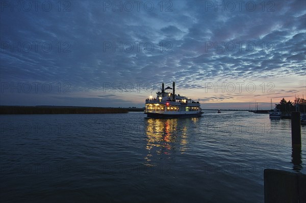 From the harbor in zingst the bodden view with burning sky with steamer, dynamic clouds in full