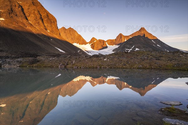 Kaskapakte glacier reflected in glacial lake, Kaskasatjakka mountain and Kuopertjakka, Kaskasavagge