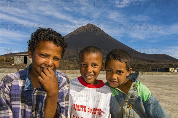 Smiling, happy boys in front of vulcano on Fogo. Cabo Verde. Africa