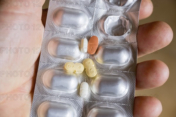 Hand holding a blister pack with tablets