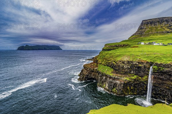 Gasadalur waterfall into the ocean, Vagar, Faroe islands, Denmark, Europe