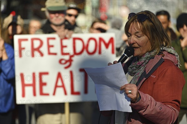 CHRISTCHURCH, NEW ZEALAND, JULY 24, 2021, A woman speaks at a protest rally at the Bridge of