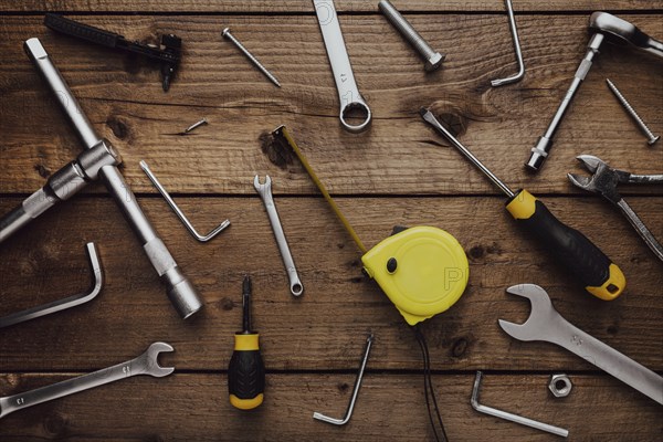 Flat lay with DYI composition of various work, carpentry tools knolled on brown wooden decks
