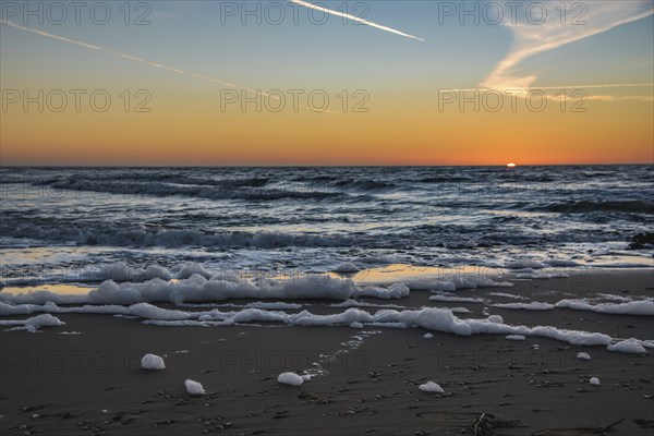 Den Helder, Netherlands. January 2022. Setting sun on the beach of Den Helder, Netherlands.