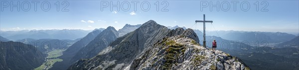 Alpine panorama, hikers at the summit cross, Westliche Wettersteinspitze, Bavaria, Germany, Europe