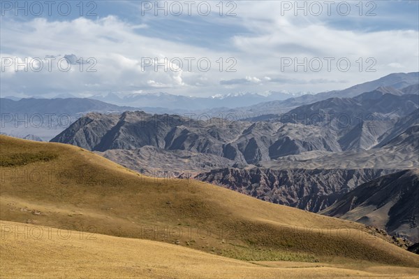 View over eroded mountainous landscape with brown hills, mountains and steppe, Chuy province,