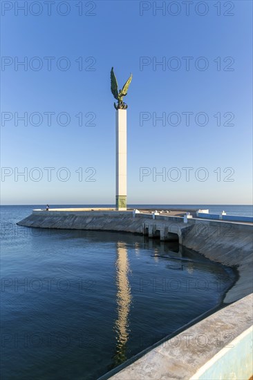 Sculpture of winged Mayan Angel on tall column, the seafront Malecon, Campeche city, Campeche