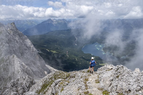 Mountaineer at Waxenstein with fog, Eibsee lake, Wetterstein Mountains, Garmisch-Patenkirchen,