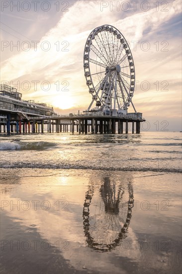 Ferris wheel at sunset on the pier at the beach, The Hague, Netherlands
