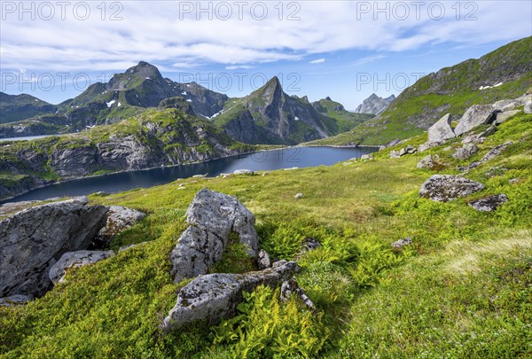 Lake Tennesvatnet and mountain landscape with rocky pointed peaks, Hermannsdalstinden mountain in