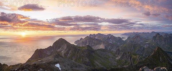 View over mountain top and sea, dramatic sunset, from the top of Hermannsdalstinden, Moskenesöy,