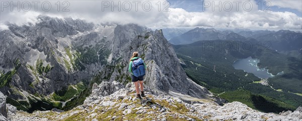 Mountaineer climbing Waxenstein, Eibsee lake and Wetterstein Mountains, Garmisch-Patenkirchen,