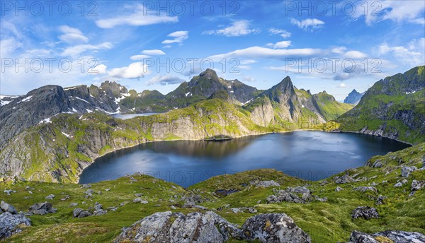 Mountain landscape with lake Tennesvatnet, at sunrise, in the back peak of Hermannsdalstinden,