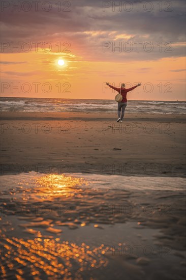 Tourist on the beach at sunset, Zandvoort, Netherlands