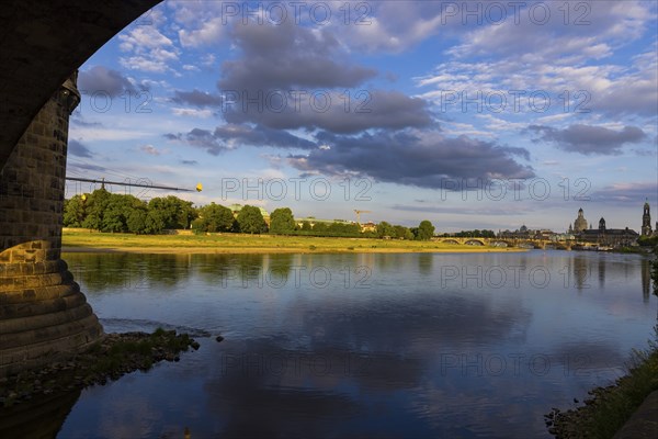 View through the arches of the Marienbrücke onto the Elbe meadows in Dresden's Old Town with
