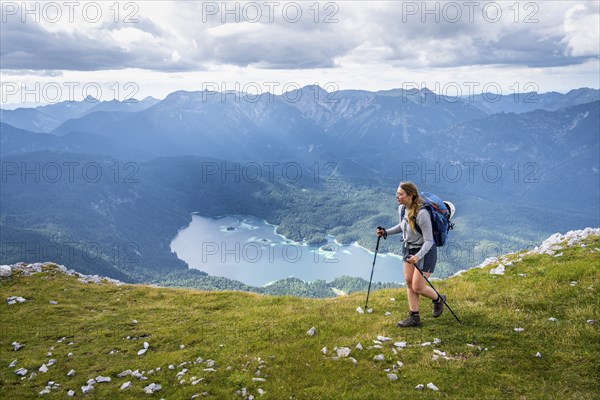 Hiker in the mountains, view of Eibsee lake and Werdenfelser Land, Wetterstein Mountains,