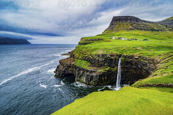 Gasadalur waterfall into the ocean, Vagar, Faroe islands, Denmark, Europe