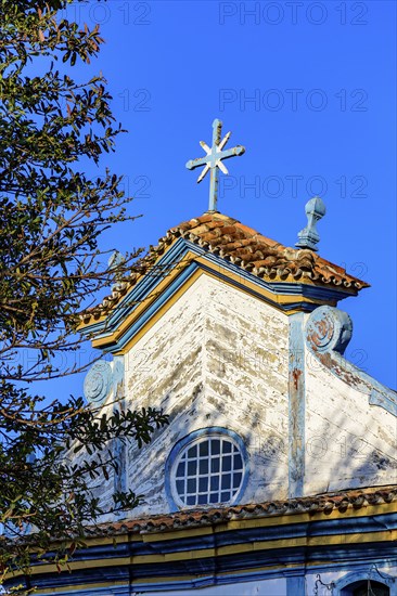 Baroque wooden church tower illuminated by the sun in the city of Diamantina, Minas Gerais, Brasil