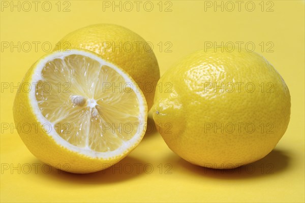 Halved lemon against a yellow background, lemon