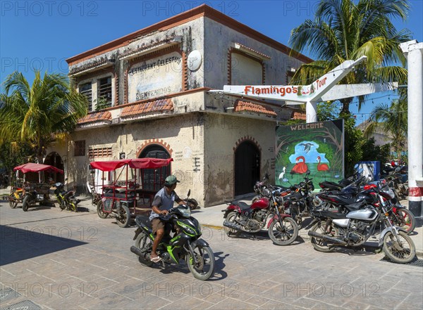Street scene with motorcycle vehicles in centre of small settlement of Celestun, Yucatan, Mexico,