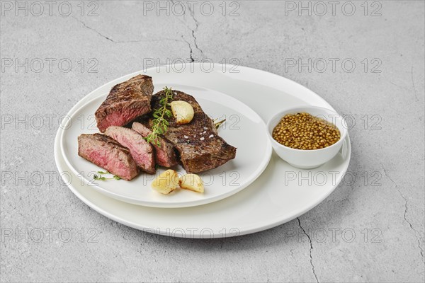 A piece of beef steak medium rare on a plate