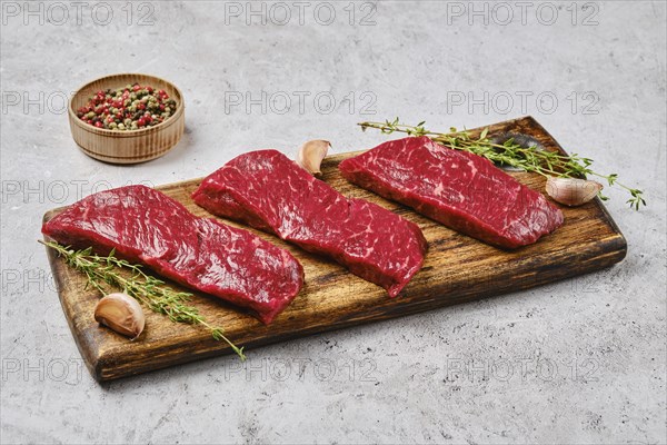 Raw fresh strip steak with spice. Prime beef meat