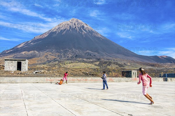Children playing football, vulcano in background. Fogo. Cabo Verde. Africa