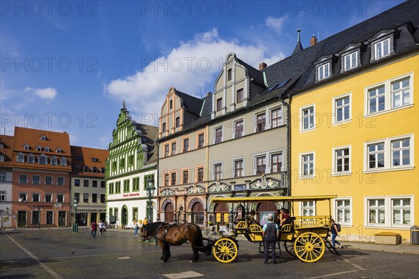 The square was given its distinctive shape in the 16th century by the town house and the