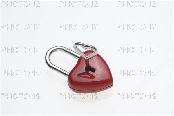 Small red padlock with a heart-shaped key